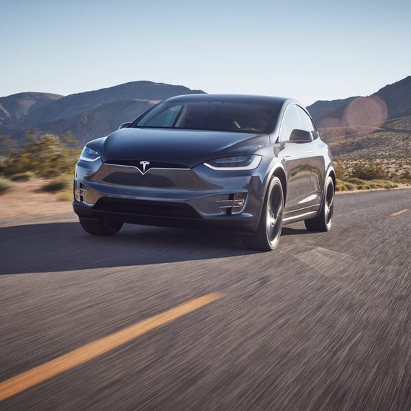 Grey Tesla Model X front driving in desert